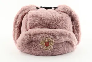 Pink faux fur ushanka hat with Russian emblem badge, warm winter trapper cap for outdoor cold.