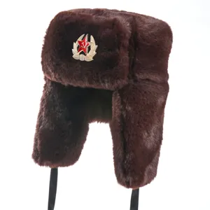 Close-up of brown winter ushanka hat with Soviet red star badge, thick plush ear flaps.