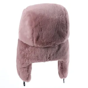 Cozy pink faux fur ushanka hat for women and men, warm winter bomber hat with ear flaps detail.