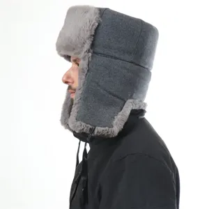 Detailed side view of grey winter trapper hat, showcasing soft faux fur and warm wool blend fabric.
