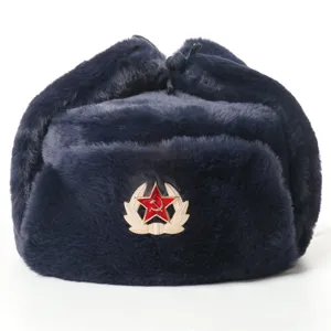 Detail view of a navy blue winter ushanka hat featuring a classic red star military emblem.