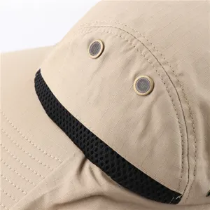 Close-up detail of outdoor sun hat, khaki ripstop fabric, breathable metal eyelets.