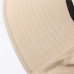 Detail view of outdoor sun hat fabric, showing durable ripstop khaki material and neat stitching.