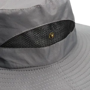 Closeup of gray outdoor sun hat mesh ventilation detail and metal snap fastener design.