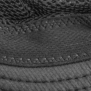 Close-up detail of black breathable mesh fabric for summer outdoor sun protection hat.