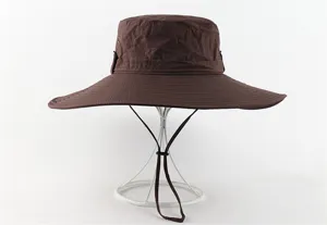 Unisex brown wide brim outdoor sun hat with breathable eyelets and adjustable wind strap.