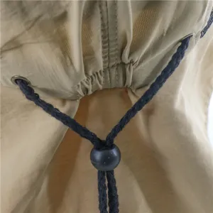 Close-up detail of the adjustable drawstring and toggle on a khaki outdoor sun hat back.