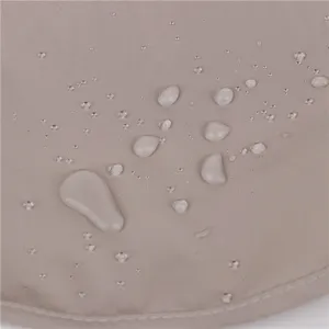 Detailed close-up view of waterproof outdoor sun hat fabric showing water droplets.