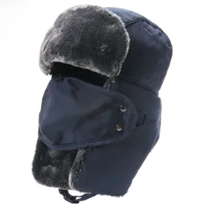 Detail shot of thick winter trapper hat in dark blue, featuring windproof mask and warm earflaps.