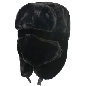 Close-up of thick black faux fur winter trapper hat with warm earflaps and face mask.