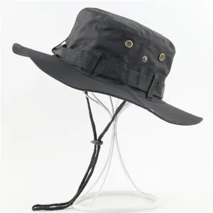 Close up view of black outdoor sun hat with windproof chin strap and metal ventilation eyelets.