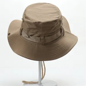 Detail view of the khaki cotton outdoor sun hat featuring web strap and wind cord.