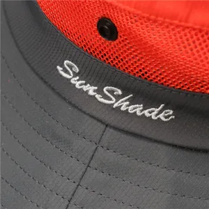 Detail view of kids sun hat brim with breathable red mesh and fine stitching texture.
