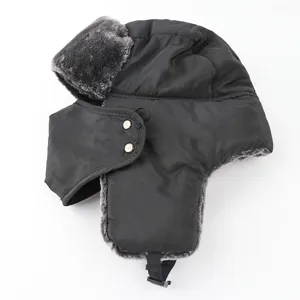 Detail view of black winter trapper hat with warm faux fur lining, windproof earflaps and mask.