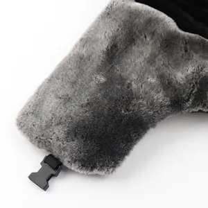 Detail view of the winter warm trapper hat earflap with soft grey faux fur and buckle.