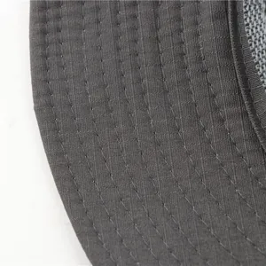 Close-up detail of dark grey sun hat brim, showing neat stitching and breathable mesh design.