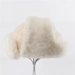 Detailed view of the soft plush white faux fur winter ushanka hat featuring cozy earflaps.