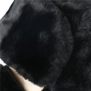 Detailed view of black faux fur ushanka hat, thick warm winter bomber hat for cold weather.