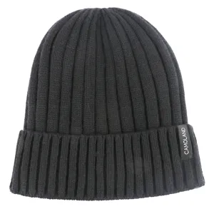 Detailed close-up view of the black ribbed knit beanie hat showcasing texture and brand tag.