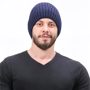 Detailed shot of a stylish dark blue ribbed knit beanie hat, comfortable winter wear.