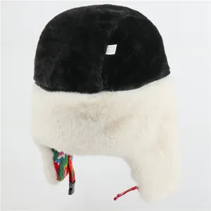 Detail of thick winter ushanka hat, black top with white faux fur and floral lining.