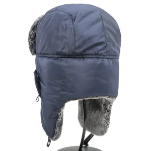 Detail view of the dark blue winter bomber hat with thick grey faux fur earflaps for outdoor.