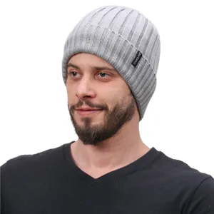 Grey ribbed knit beanie close-up, showing detailed fabric texture and stylish side logo tag.