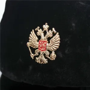 Black winter ushanka hat with golden double headed eagle emblem, warm windproof cold weather cap.