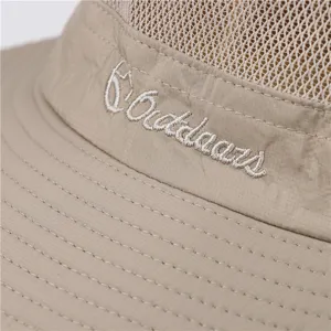 Close-up of breathable mesh outdoor sun protection bucket hat khaki fabric and fine stitching.