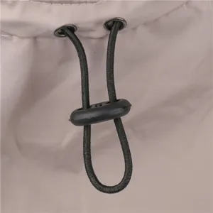 Detailed close-up view of adjustable black elastic drawstring and cord lock on outdoor sun hat.