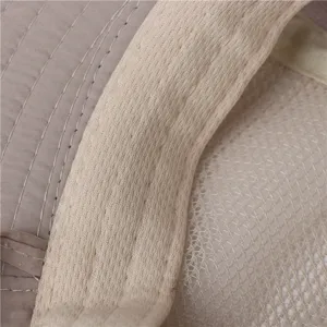 Close-up detail of outdoor sun hat, quilted fabric and breathable mesh, fine stitching design.