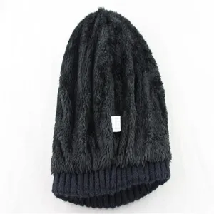 Detailed view of winter black fleece lined knitted beanie hat, warm texture close up.