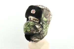 Detailed view of a thick camo ushanka hat with earflaps, face mask, and vintage Soviet red star badge.