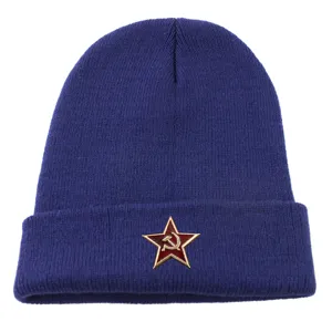 Blue knit beanie hat detail showing the red star metal badge, warm winter style.