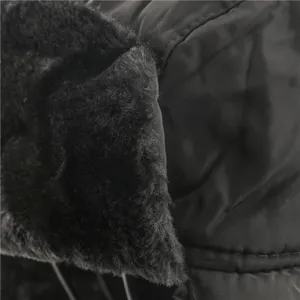 Winter warm earflap hat detail shot, thick plush faux fur and windproof black shell design.