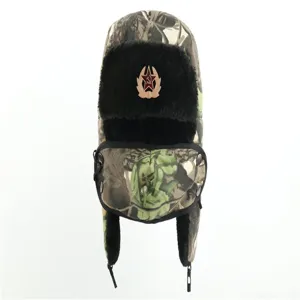 Detailed view of thickened camouflage ushanka hat with earflaps and Soviet star badge.