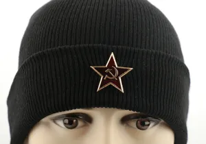 Black knitted beanie hat with retro Soviet red star metal badge, warm winter headwear.