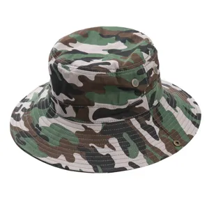 Close-up detail of the camouflage bucket hat, showing fabric texture and eyelets.