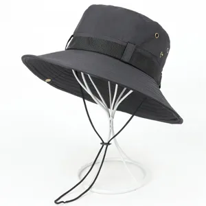 Black outdoor sun protection bucket hat detail, featuring windproof chin strap and breathable eyelets.