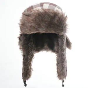 Detailed close-up of the thick brown plaid trapper hat, showing soft faux fur and earflaps.