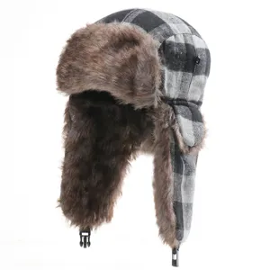 Close-up detail of black and white plaid winter hat showing soft brown faux fur and earflaps.