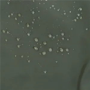 Close-up detail of waterproof fabric texture showing excellent water repellent performance.