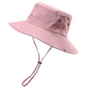 Pink outdoor bucket hat detail, sun protection fabric, adjustable chin strap, metal eyelets.