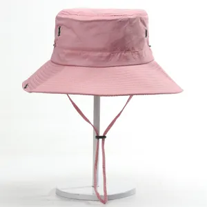 Pink outdoor bucket hat with chin strap, waterproof and sun protection hiking wear detail.