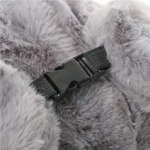Close-up detail of grey faux fur trapper hat showing durable black plastic buckle and strap.