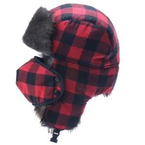 Red and black plaid trapper hat detail shot, showing thick faux fur lining, ear flaps and face mask.