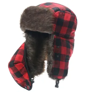Detailed view of the red and black buffalo plaid winter trapper hat with soft faux fur lining.