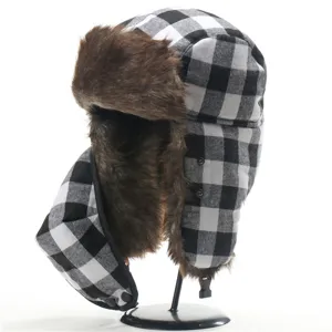 Details of the black and white buffalo plaid ushanka hat with warm brown faux fur lining.