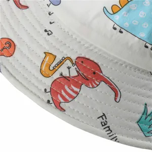 Close-up detail of children cotton bucket hat brim, cute cartoon dinosaur print, fine stitching.