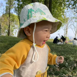 Cute cotton toddler bucket hat with cartoon crocodile print for outdoor sun protection.
